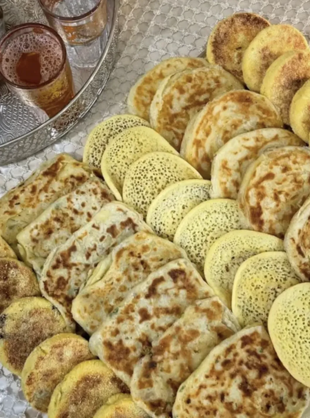 Assortiment de msemmen, baghrir et harcha avec thé à la menthe